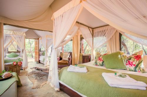 a bedroom with a canopy bed in a tent at Zwartkloof Adventures Tented Camp in Bela-Bela