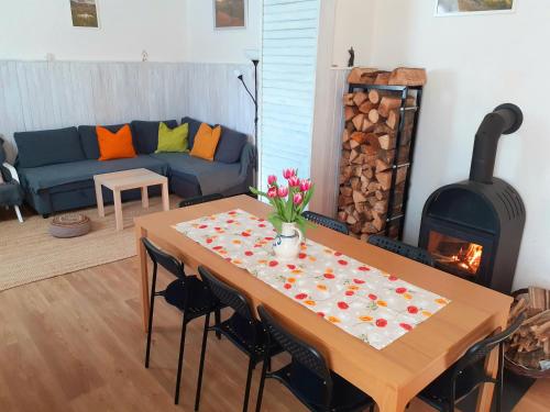 a living room with a table with flowers on it at Chalupa U přátel in Kovářská