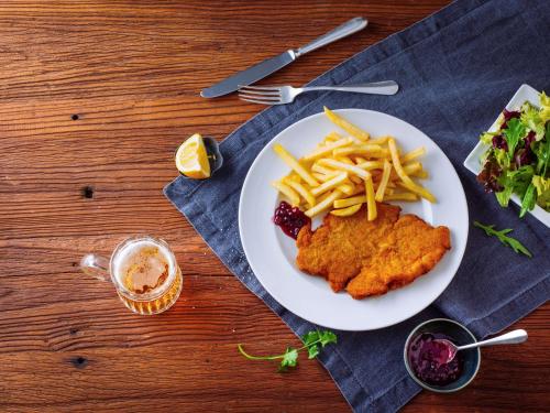 a plate of food with chicken and french fries at Ibis Hamburg City in Hamburg