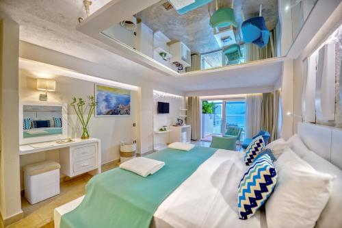 a bedroom with a large bed with a green comforter at Peninsula Gardens Hotel in Kas