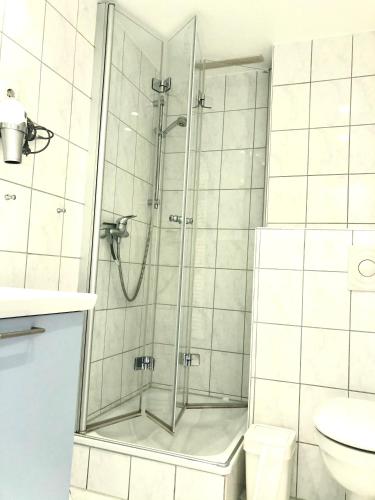 a shower with a glass door in a bathroom at Strandbude 204 in Heiligenhafen