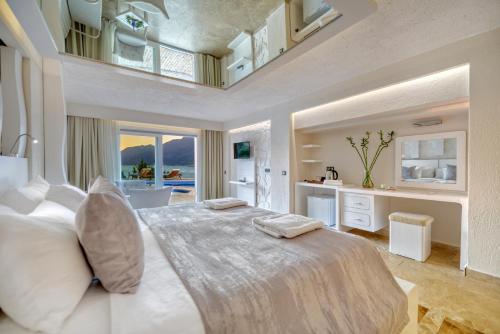 a bedroom with a large bed with a view of the ocean at Peninsula Gardens Hotel in Kas