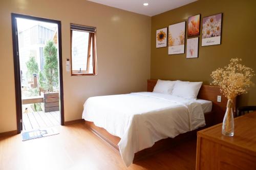 a bedroom with a large white bed and a window at Ninh Binh The View Point Home & Spa in Ninh Binh