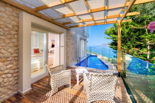 a patio with two chairs and a swimming pool at Peninsula Gardens Hotel in Kas