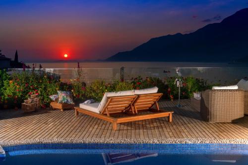 a couch sitting on a deck next to a pool at Peninsula Gardens Hotel in Kas