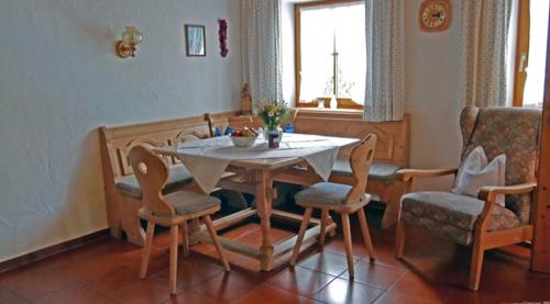 a dining room with a table and chairs and a couch at Gschwendtner-Hof Ferienhof mit Wildgehege in Schleching