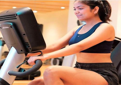 a woman sitting in front of a computer monitor at Novotel Chennai OMR in Chennai
