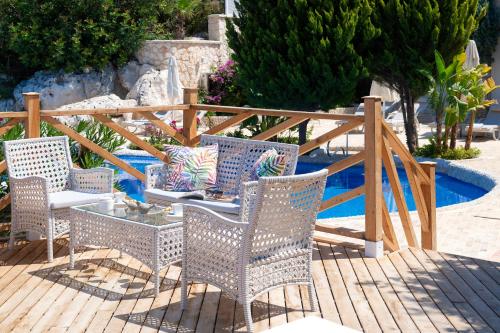 a group of chairs and a table on a wooden deck at Peninsula Gardens Hotel in Kas