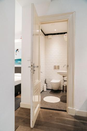 a bathroom with a toilet and a sink at Spui apartment in center in Amsterdam