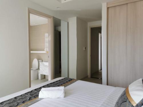 a bedroom with a bed with a large mirror at Gold Coast Luxury Apartment Nha Trang in Nha Trang