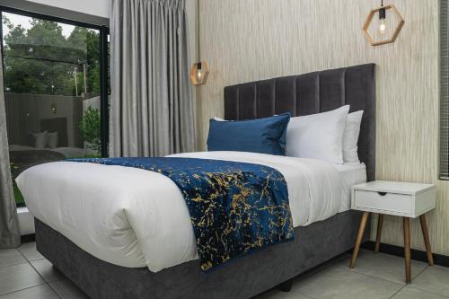 a bedroom with a large bed and a window at Residence at Montego in Sandton