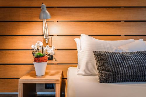 a bedroom with a bed and a table with a lamp at Lake Front Hotel Mirage in Riva del Garda