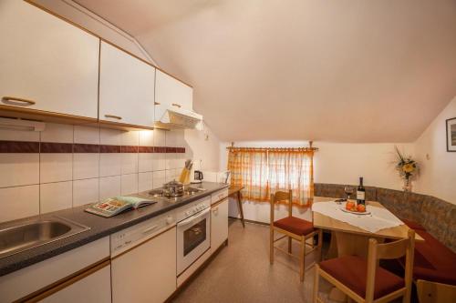 a kitchen with a sink and a table with a dining room at Ferienwohnung Brugger 4 Personen in Kaltenbach