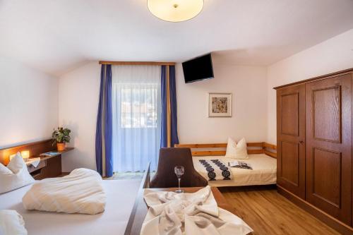 a hotel room with two beds and a window at Ferienwohnung Brugger 4 Personen in Kaltenbach