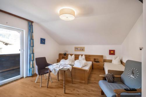 a living room with a table and chairs at Ferienwohnung Brugger 4 Personen in Kaltenbach