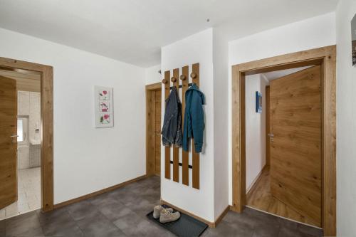 a hallway with two doors and a door with bats on the wall at Ferienwohnung Brugger 4 Personen in Kaltenbach