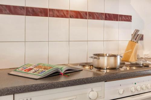 a kitchen counter with a pot and a book on it at Ferienwohnung Brugger 4 Personen in Kaltenbach
