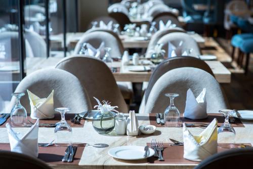 a row of tables and chairs in a restaurant at Vittori Palace Hotel and Residences in Riyadh