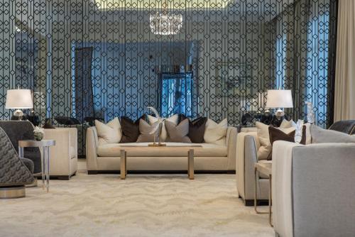a living room with two couches and a table at Vittori Palace Hotel and Residences in Riyadh