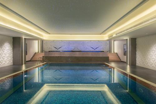 a swimming pool in the middle of a building at Vittori Palace Hotel and Residences in Riyadh