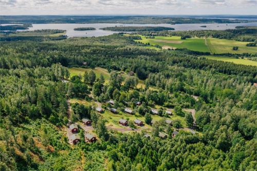 an aerial view of a park with trees and a lake at Holiday House with beautiful scenery near Göta Kanal in Undenäs