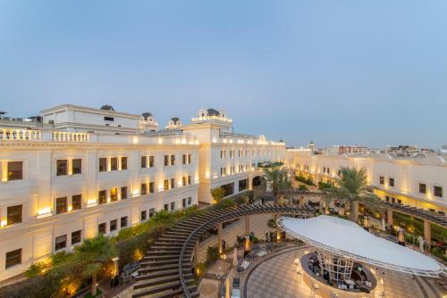a large white building with a skate park in front of it at Vittori Palace Hotel and Residences in Riyadh