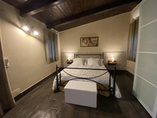 a bedroom with a bed and two lamps on the floor at Villa Conti in Giardini Naxos