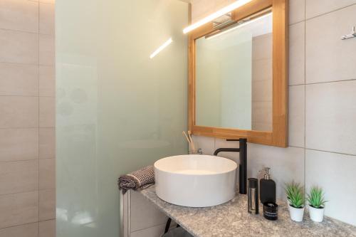 a bathroom with a sink and a mirror at Giorgio Deluxe Studio in Kattavía