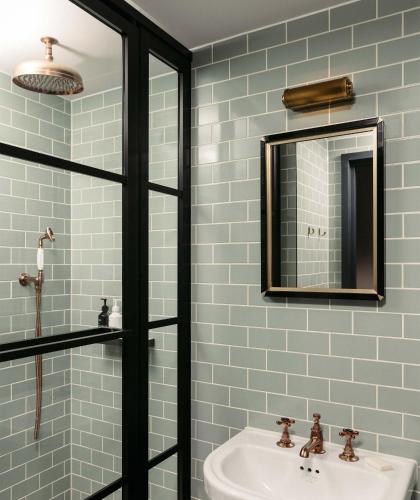 a bathroom with a sink and a mirror at The Hoxton, Southwark in London
