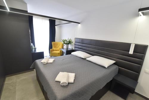 a bedroom with a bed with two towels on it at Mido Rooms in Zadar