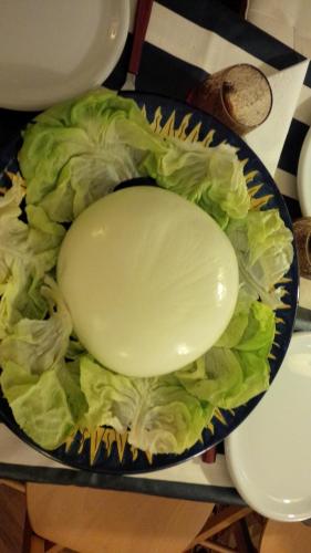 a bowl of lettuce with a large onion on it at Villa Casale Ravello Residence in Ravello