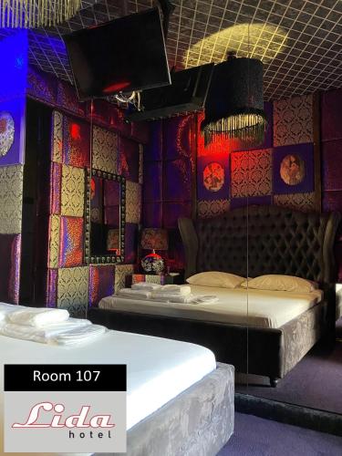 two beds in a room with colorful walls at Lida Hotel in Athens