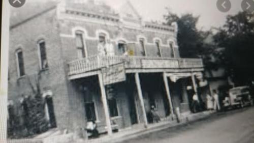 a black and white photo of an old brick building at The Burlington Hotel & Bar - Alma WI in Alma
