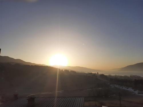 a sun setting over a valley with a river at Айрови in Sarnitsa