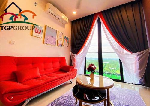 a living room with a red couch and a window at Legoland D'PRISTINE Apartment By TGP in Nusajaya