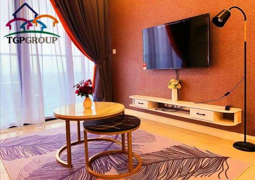 a living room with a table and a tv at Legoland D'PRISTINE Apartment By TGP in Nusajaya