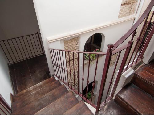 a stairway with a dog sitting in a window at Residenze al Castello Apartments in Cagliari