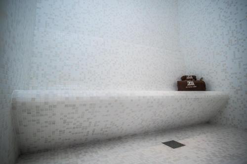 a bathroom with a shelf with a toaster on it at Hotel São Bento da Porta Aberta & Spa in Geres