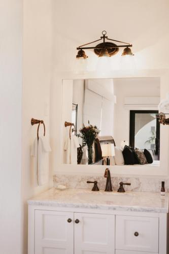 a bathroom with a sink and a mirror at La Marina Inn in San José del Cabo