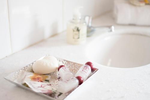 a tray with an egg on a bathroom sink at Pousada Do Largo in Tiradentes