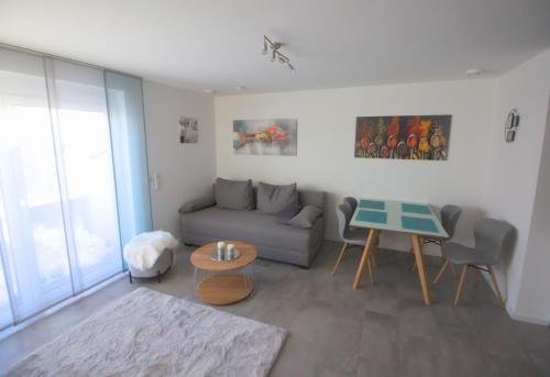 a living room with a couch and a table at Ferienwohnung Hegaublüte in Engen