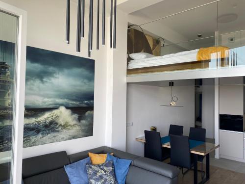 a living room with a couch and a bunk bed at The Baltic Horizon in Dziwnówek
