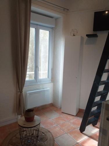 a living room with a window and a table at Studio hyper centre entre port et plage in Les Sables-dʼOlonne