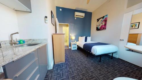 a hotel room with a bed and a sink at Stylish Downtown Studio in the SouthEnd, C.Ave #43 in Boston