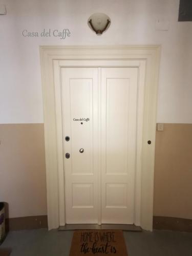a door in a room with a sign on the wall at Casa del Caffè in Trieste