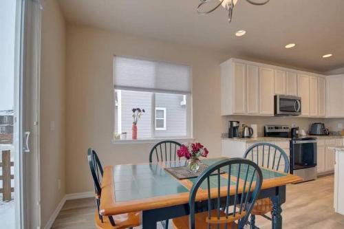 a kitchen and dining room with a table and chairs at Large Brand-New Home Close to Lake & Mountains in Monument