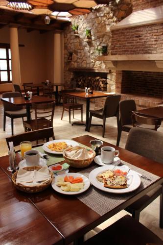 a table with plates of food on it in a restaurant at La Estancia in San Cristóbal de Las Casas