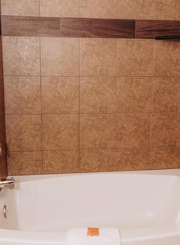 a tiled wall above a bath tub in a bathroom at Pacific Inn Motel in Forks