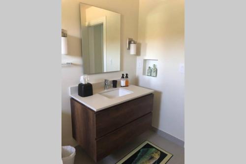 a bathroom with a sink and a mirror at Azuero Lodge: Luxury Beachfront condo- Playa Venao in Playa Venao