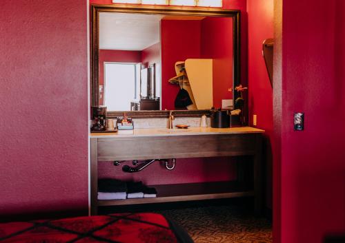 a bathroom with a sink and a mirror at Pacific Inn Motel in Forks
